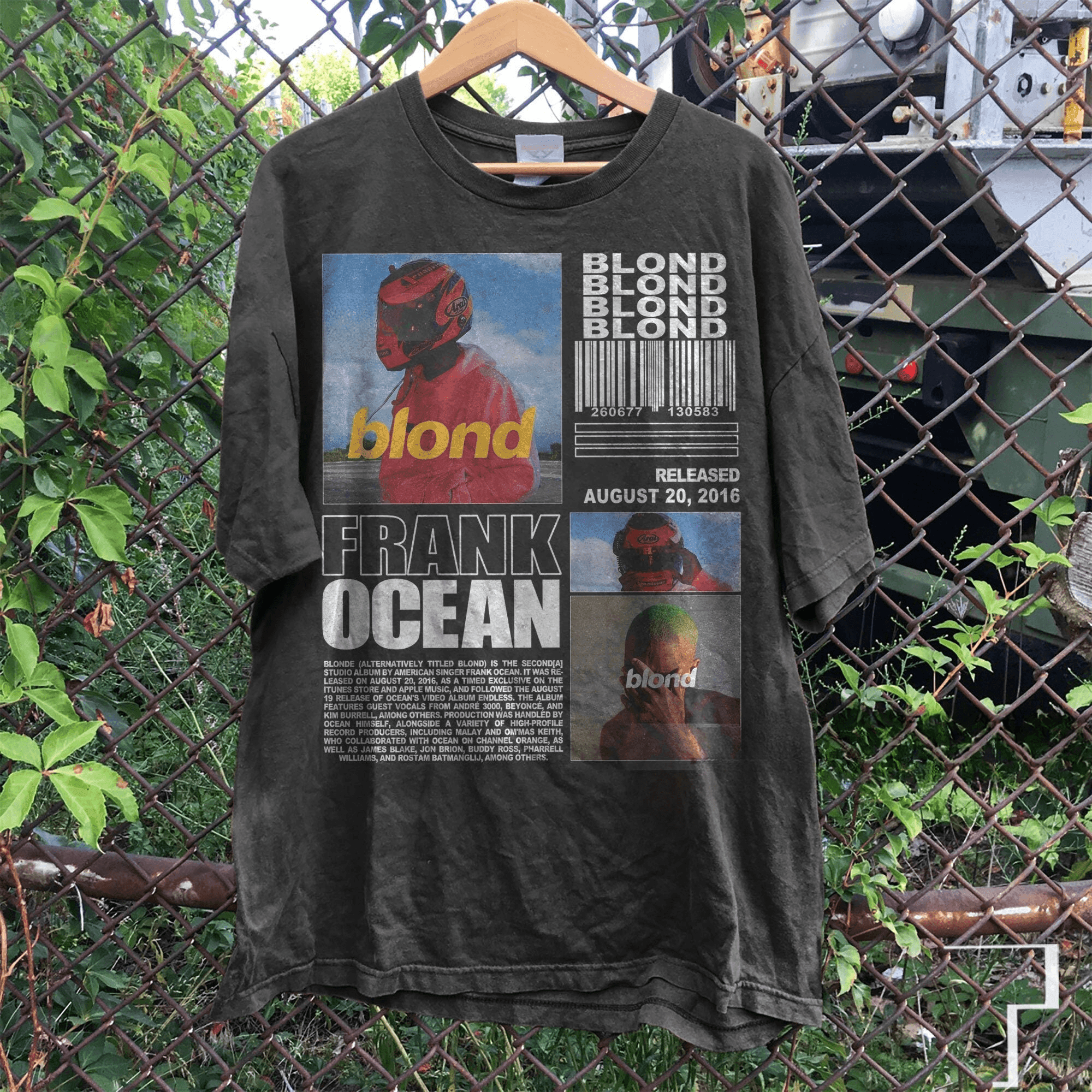 a t - shirt hanging on a chain link fence