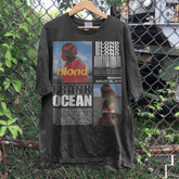 a t - shirt hanging on a chain link fence