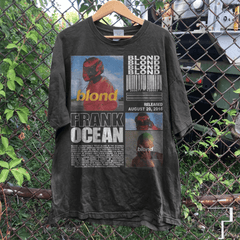 a t - shirt hanging on a chain link fence