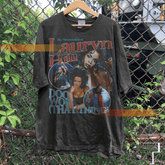 a t - shirt hanging on a chain link fence