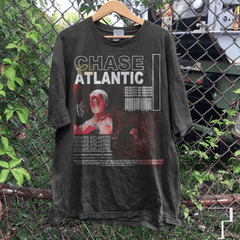 a t - shirt hanging on a chain link fence