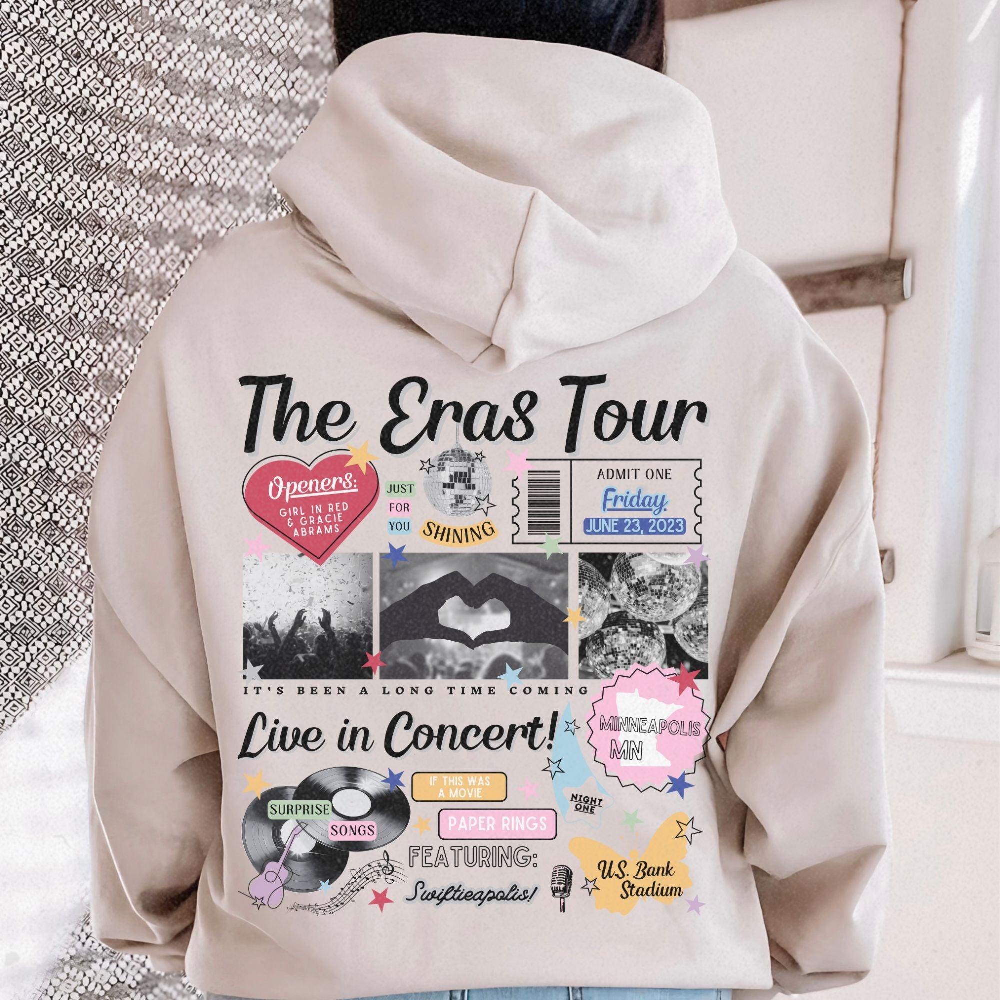 a person wearing a hoodie with the words the eras tour on it