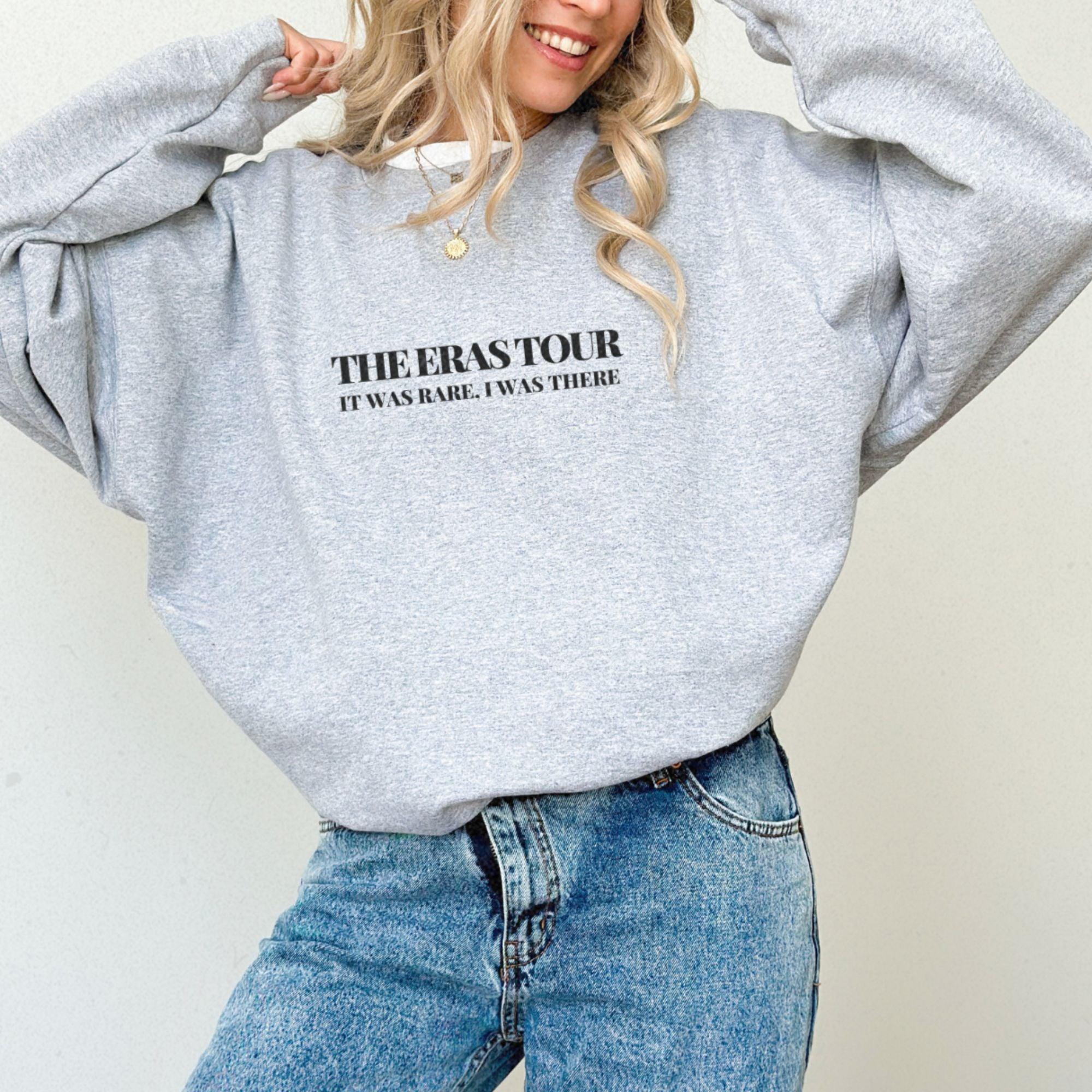 a woman with blonde hair wearing a grey sweatshirt