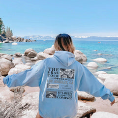 a woman standing on a beach with her back to the camera