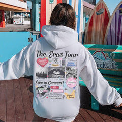 a person in a white hoodie is sitting on a bench