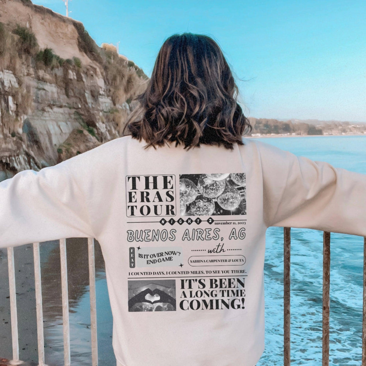 a person standing on a railing looking at the ocean