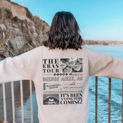 a person standing on a railing looking at the ocean