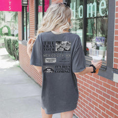 a woman is standing outside of a coffee shop