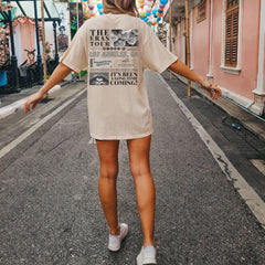 a woman walking down a street with balloons in the background