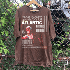 a t - shirt hanging on a chain link fence