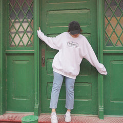 a person leaning against a green door