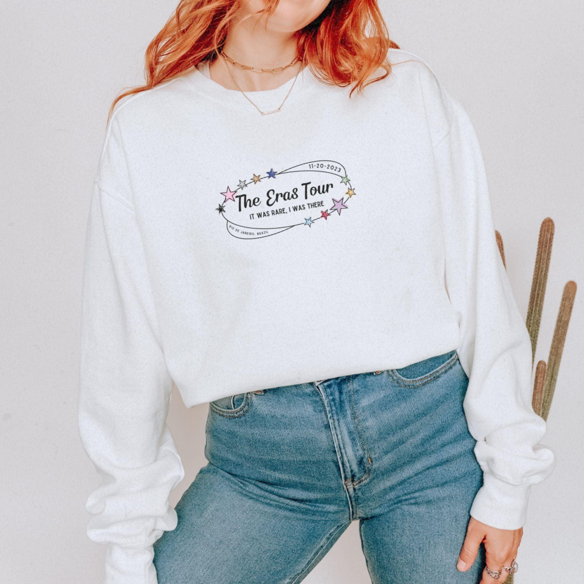 a woman with red hair wearing a white sweatshirt