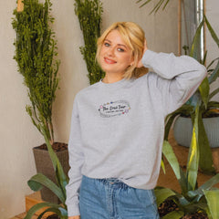 a woman standing in front of a potted plant