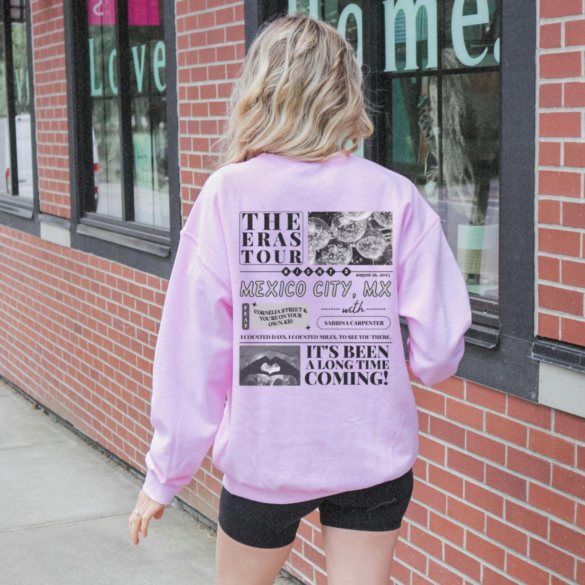 a woman walking down a sidewalk next to a building