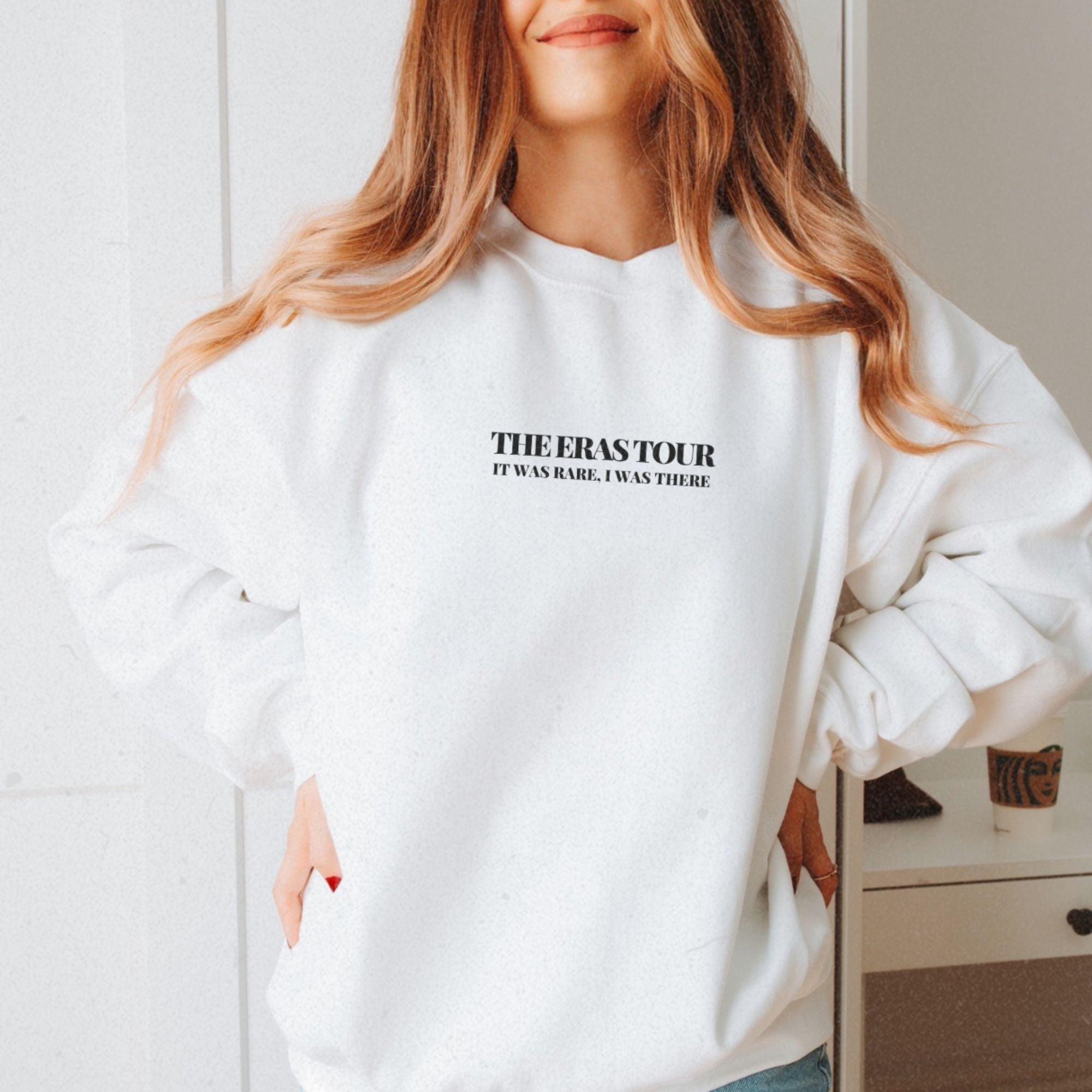 a woman wearing a white sweatshirt with the words, the eraser on it