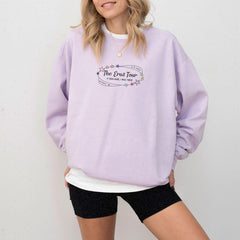 a woman wearing a purple sweatshirt and black shorts