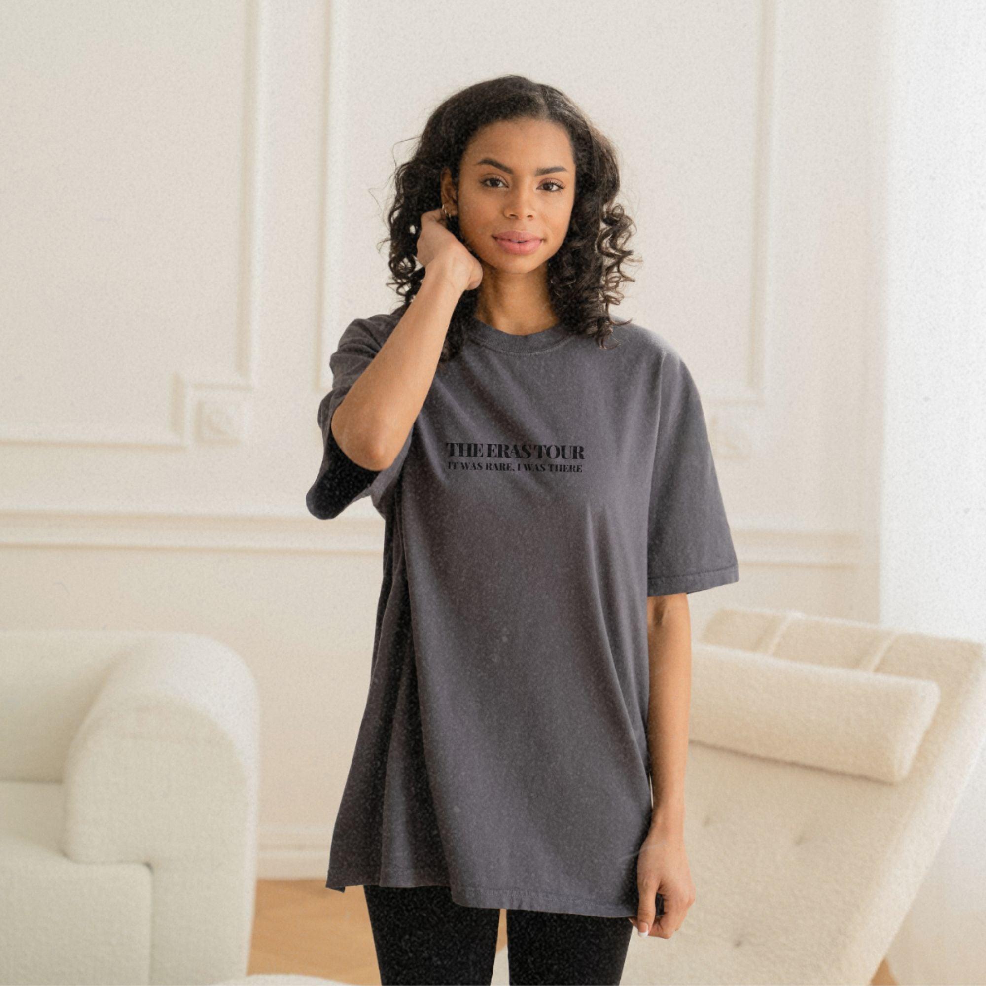 a woman standing in a living room talking on a cell phone